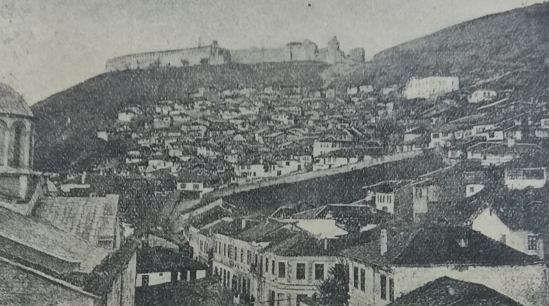 Old stone bridge and cobbled lanes of Prizren at hazy sunset